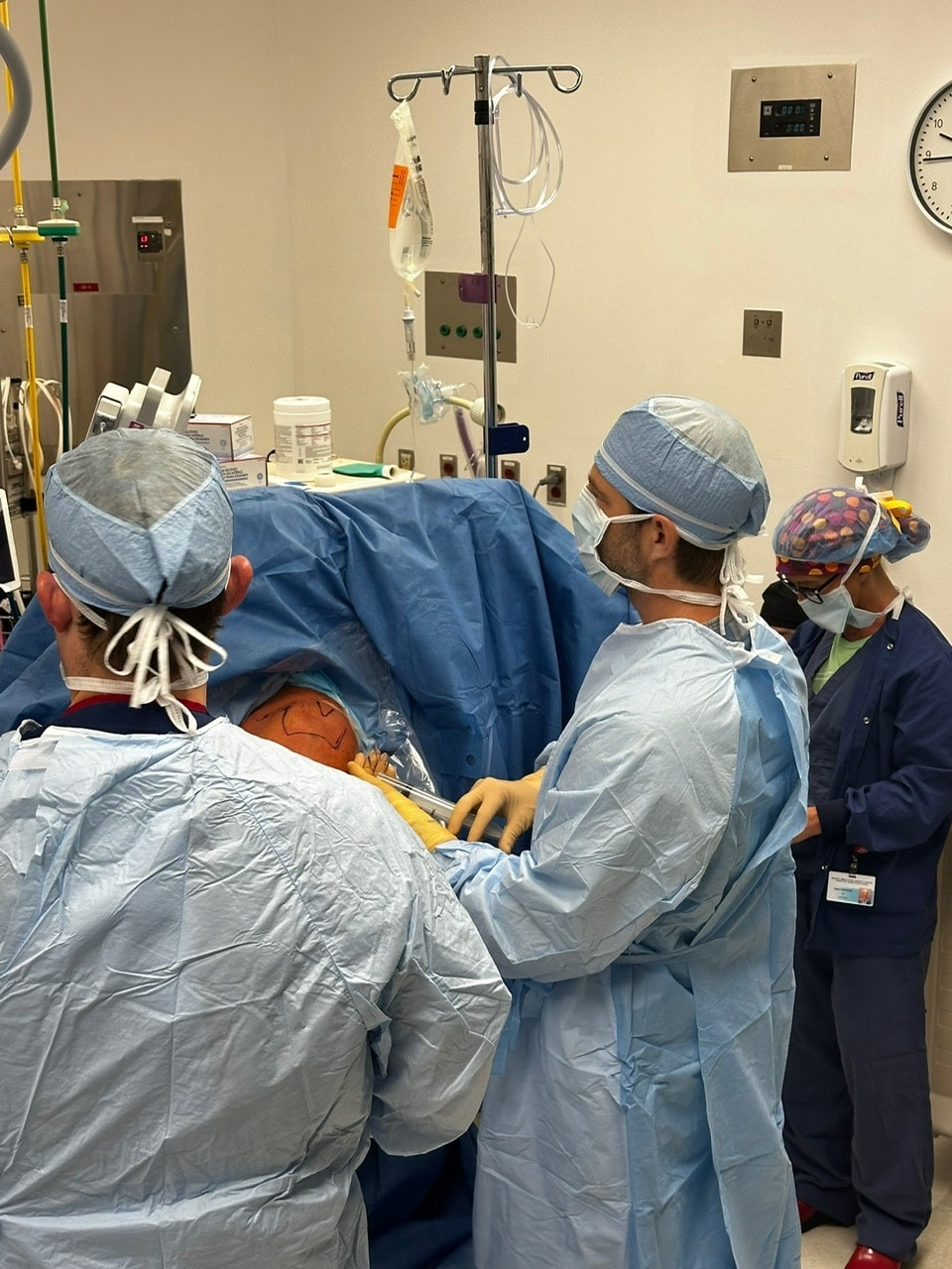 Dr. Jason Jones operating on a shoulder with his surgical team