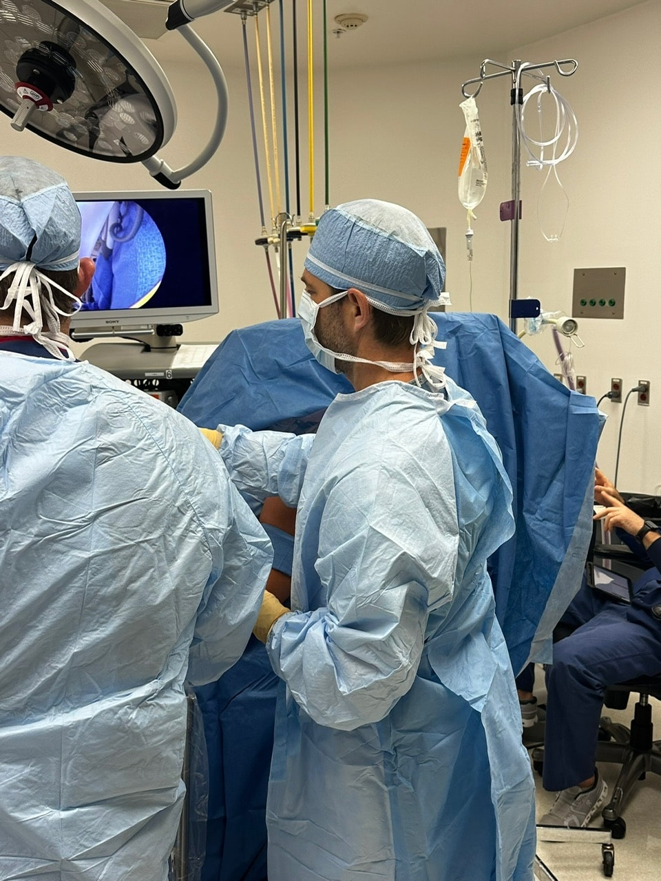 Dr. Jason Jones at the operating table, the arthroscope view on the screen beside him