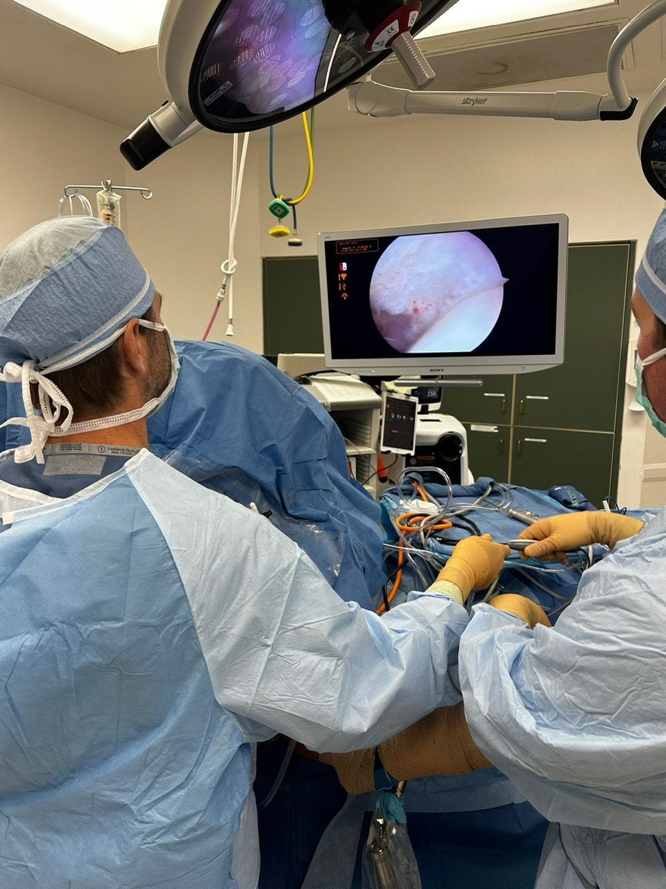 Dr. Jason Jones performing arthroscopic surgery, watching the camera view on the monitor